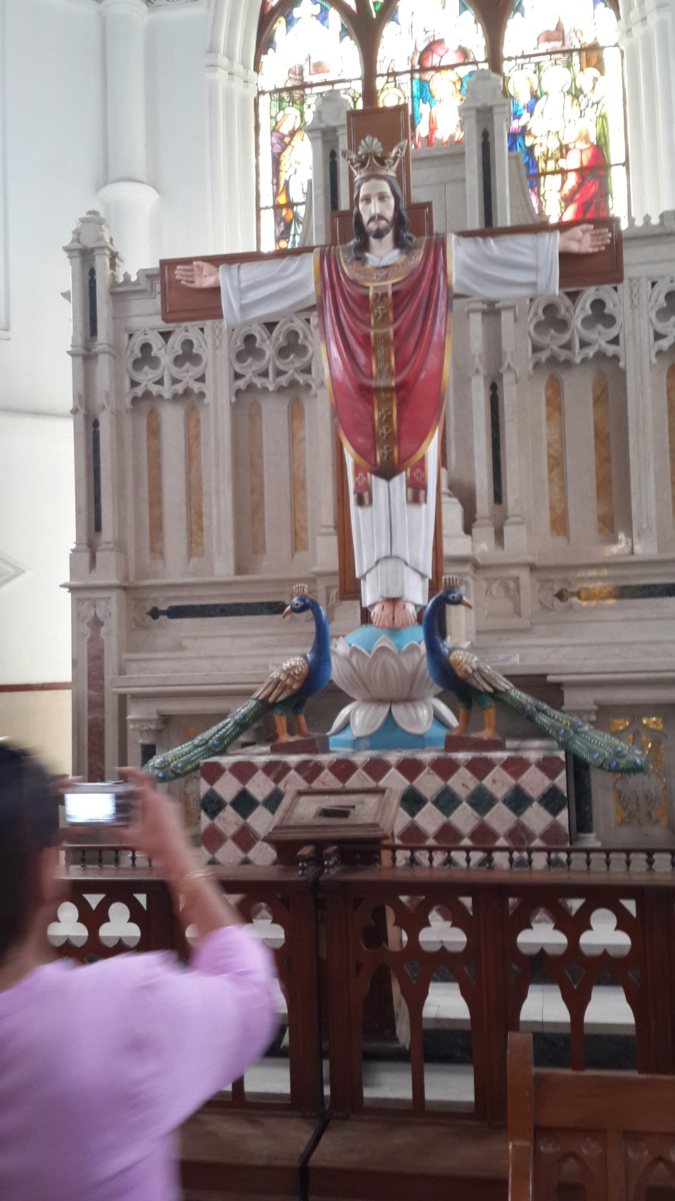lotus feet flanked by peacocks